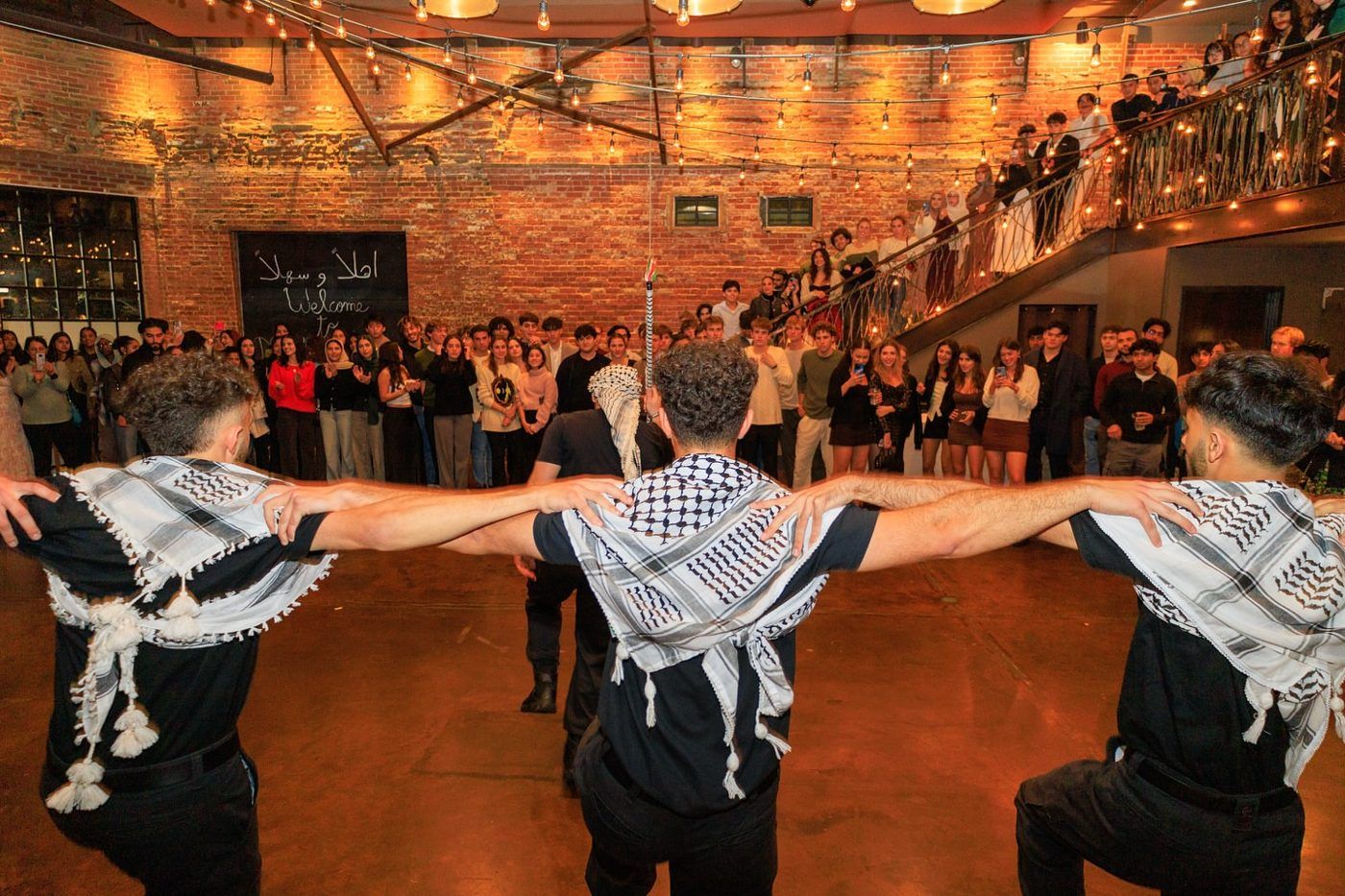 Hayat Al-Dabka dabka line with keffiyehs in a ballroom at a wedding, North Carolina