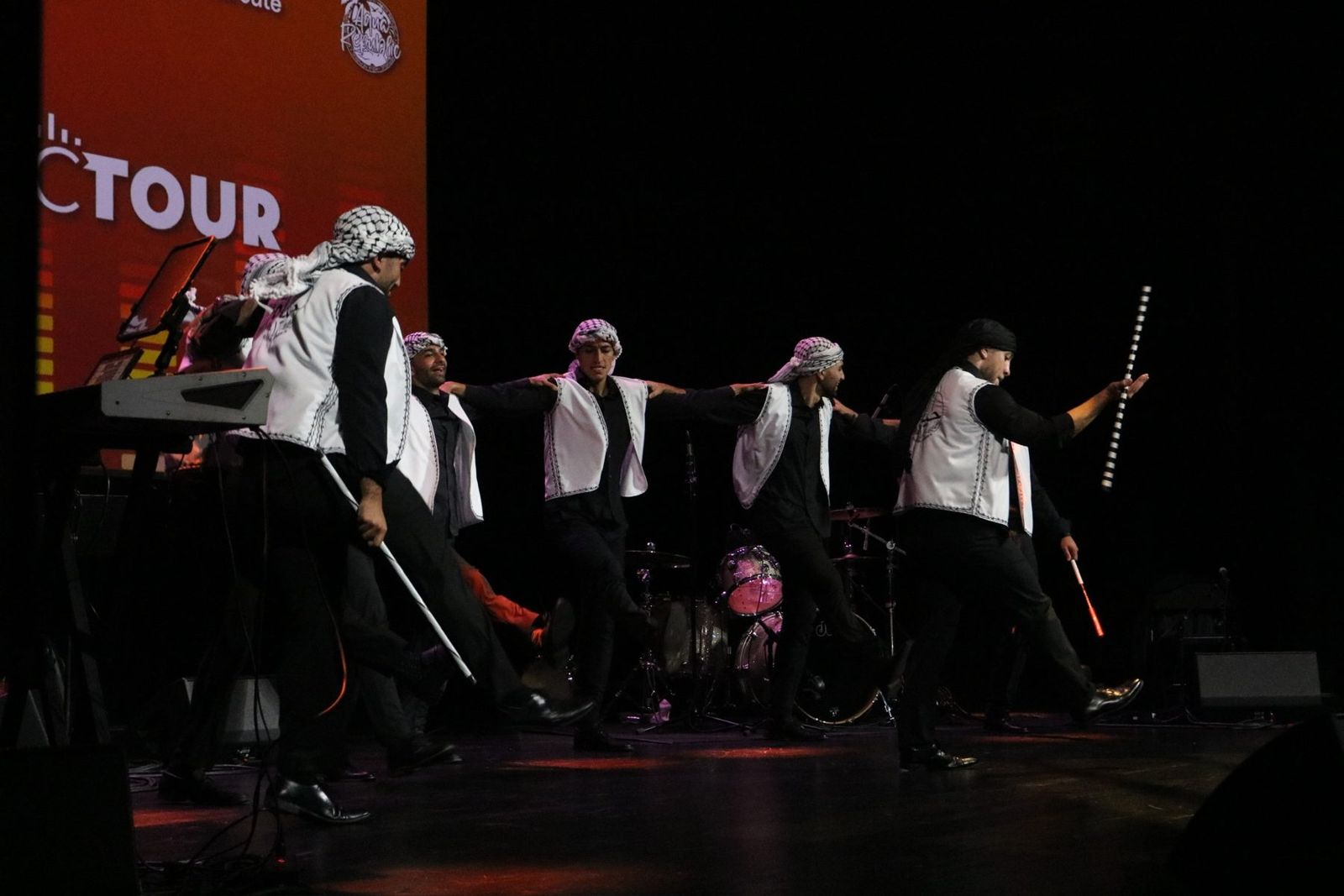 Hayat Al-Dabka, the North Carolina dabka group, performing a dabka set on stage at a concert