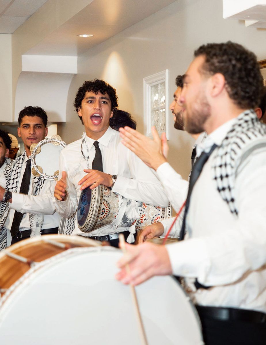 Hayat Al-Dabka drummer in a keffiyeh leading a wedding zaffa, Raleigh NC